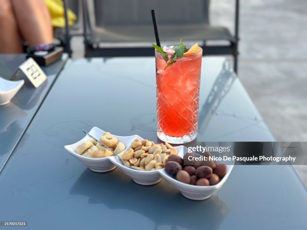 Close-up of red fruits mojito cocktail on a table