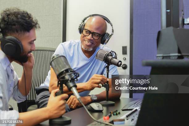 men discuss politics while recording podcast in modern studio - radio broadcasting stock pictures, royalty-free photos & images