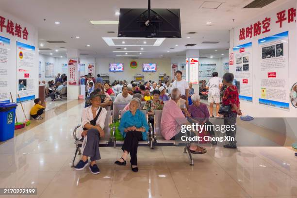 Citizens gather inside a civil defense facility to escape the summer heat, taking advantage of the cool environment provided by the underground...
