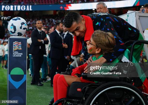 Cristiano Ronaldo of Portugal with young supporter before the start of the UEFA Nations League 2024/25 League A Group A1 match between Portugal and...