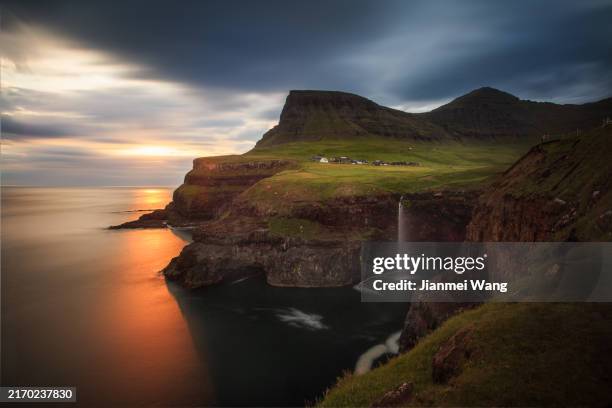 sunset over gásadalur waterfall - faroe islands stock pictures, royalty-free photos & images