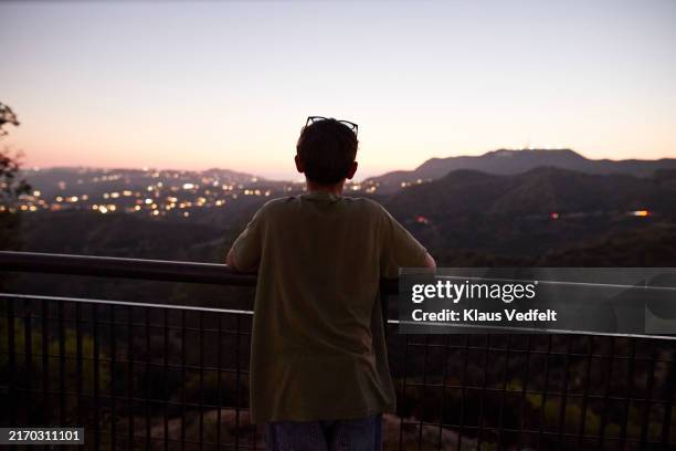 teenage boy looking at hills during dusk - southern california stock pictures, royalty-free photos & images