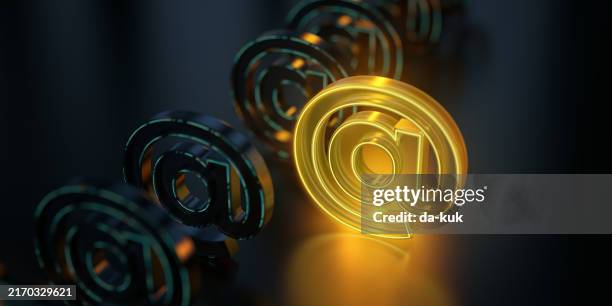 e-mail at icon glowing on dark background. futuristic email sign in world of technological progress and innovation. cgi 3d render - at symbol stock pictures, royalty-free photos & images