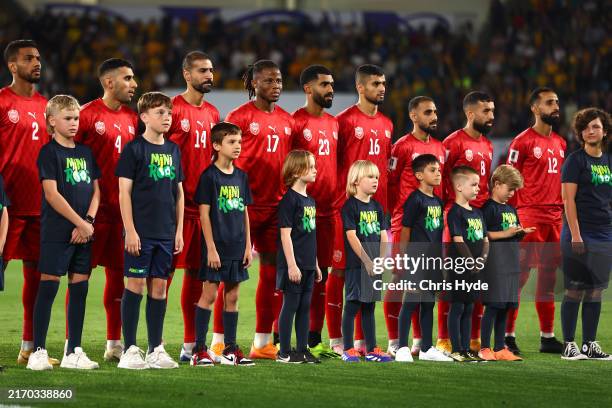 Members of Team Bahrain stand and sing the national anthem before the round three 2026 FIFA World Cup AFC Asian Qualifier match between Australia...