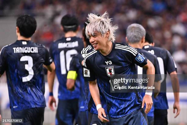 Junya Ito of Japan celebrates after scoring the team's fifth goal with his teammate during the FIFA World Cup Asian 3rd Qualifier Group C match...