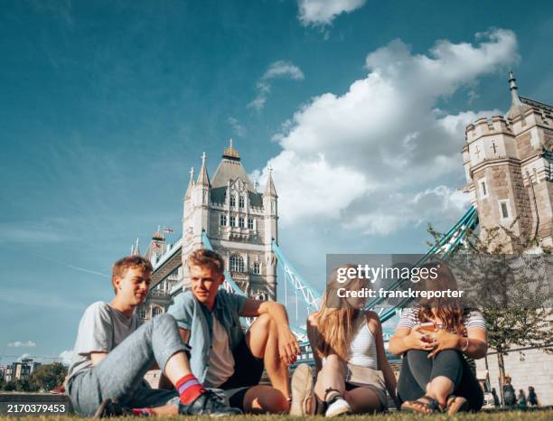 people having fun together in a public park - england stock-fotos und bilder
