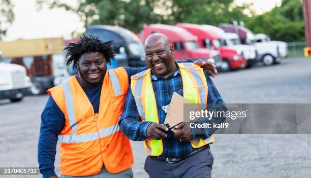 african-american father, son working at trucking company - southern pride trucking stock pictures, royalty-free photos & images