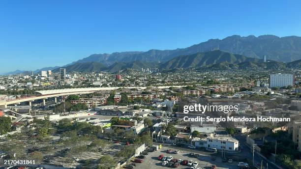 aerial panoramic view of the cityscape and surrounding mountains in monterrey, nuevo leon, mexico - monterrey aerial stock pictures, royalty-free photos & images