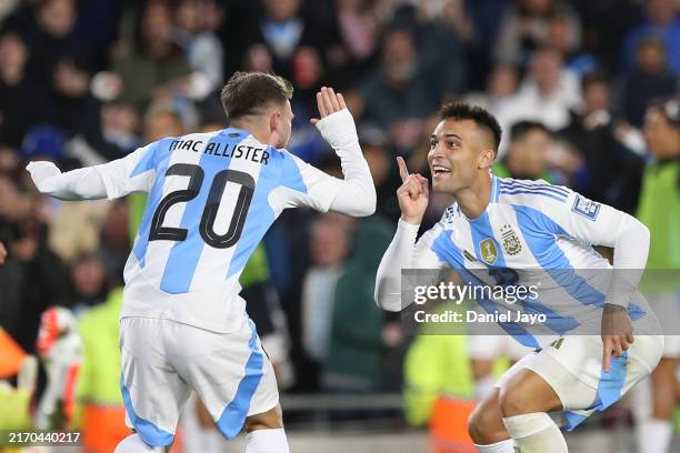 Alexis Mac Allister of Argentina celebrates after scoring the team's first goal with teammate Lautaro Martinez of Argentina during the FIFA World Cup...