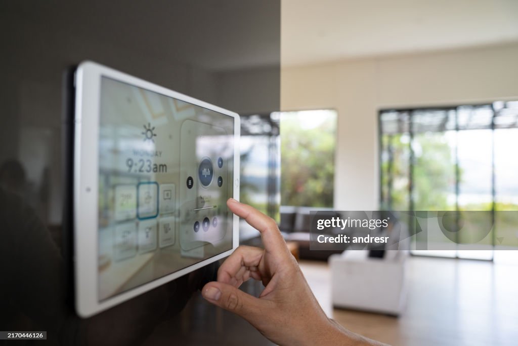 Close-up on a person using a home automation system to control the music