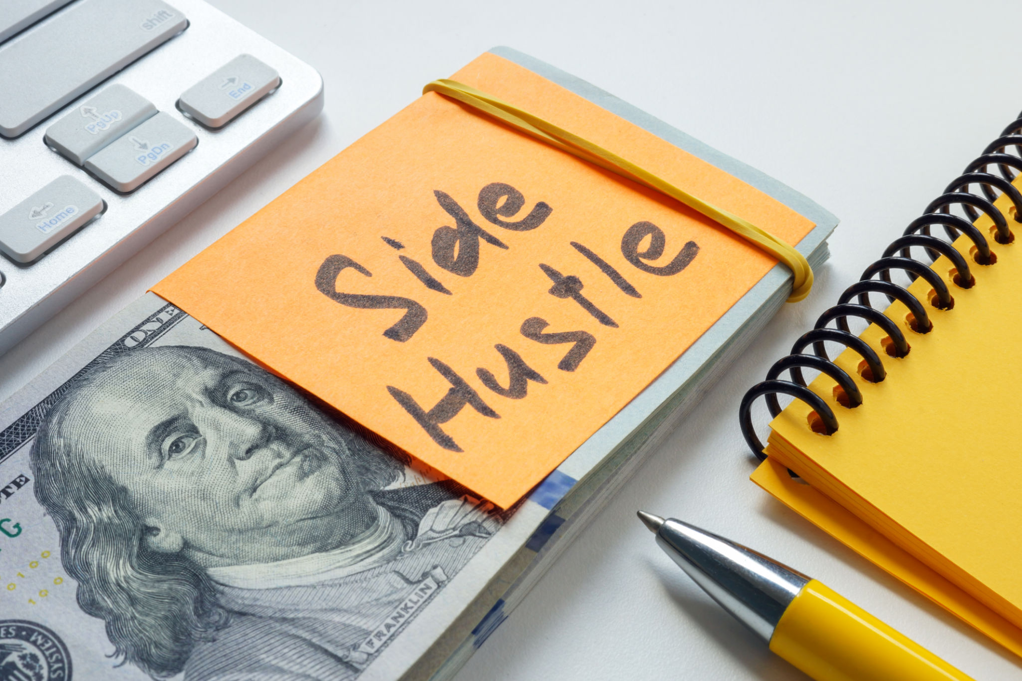 Stack of money labeled side hustle. Additional income and entrepreneurial ventures. Stack of money labeled side hustle. Additional income and entrepreneurial ventures.