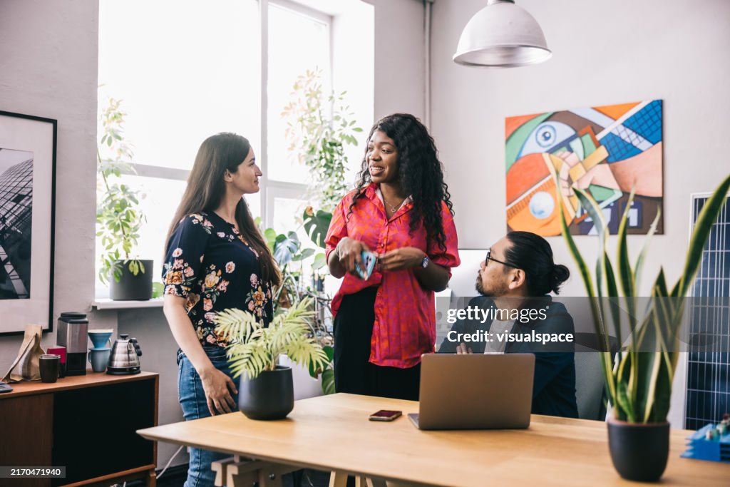 Three team members having a meeting in a cozy workspace