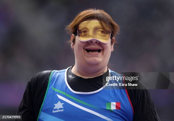 Assunta Legnante of Team Italy reacts whilst wearing an eye mask depicting the portrait of Leonardo da Vinci's 'Mona Lisa' during the Women's Shot...