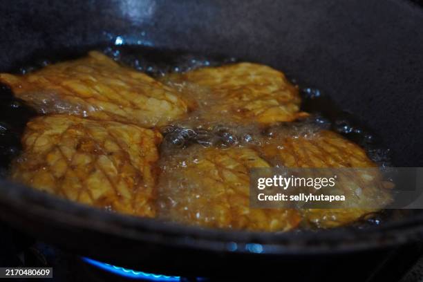 frying tempeh - tempeh stock pictures, royalty-free photos & images