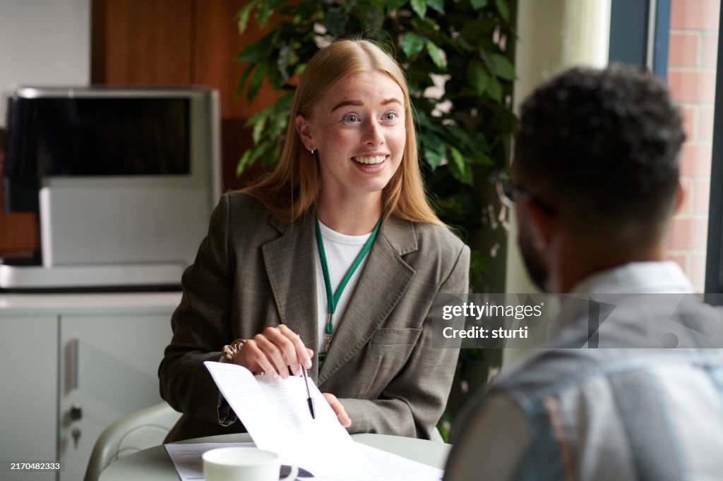 Housing officer assisting a tenant with forms