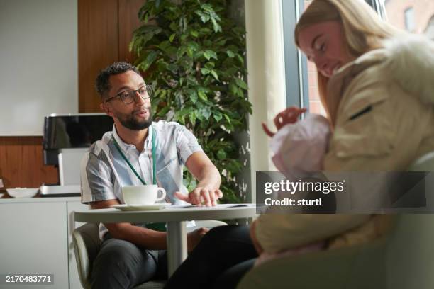 young mum with social housing worker - psych ward stock pictures, royalty-free photos & images