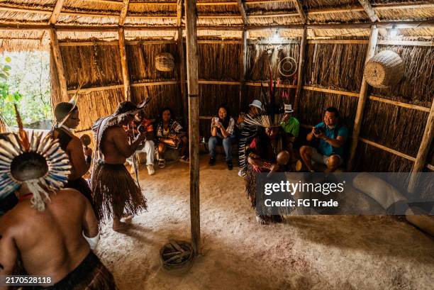 indigenous people from the wassú tribe performing traditional toré ritual during a tourist visit to the village - authentic native american headdress stock pictures, royalty-free photos & images