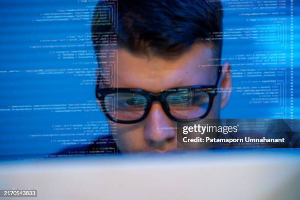 male programmer, deeply immersed in the design of an e-commerce app, works confidently at his home office desk. surrounded by multiple screens and advanced technology, he embodies innovation and solution-oriented thinking. power of coding. - computer mainframe stock pictures, royalty-free photos & images
