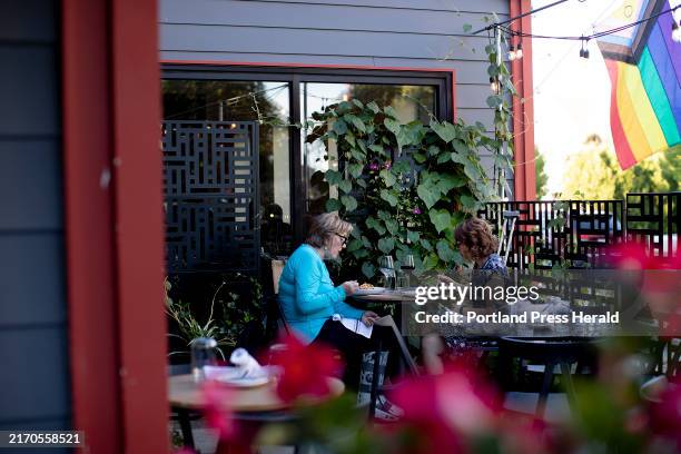 Susan Lapping of Kernersville, N.C., left, and Kelly Pallitto of Bath dine on the deck at Linden + Front in Bath.