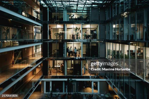 modern office building by night in paris, france - idee stockfoto's en -beelden