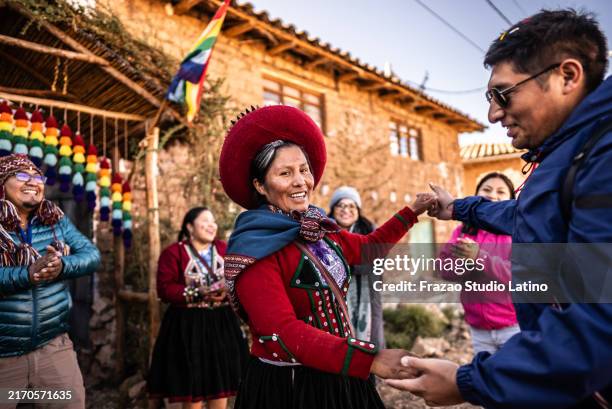 portrait d’un chinchero indigène dansant avec un touriste, dans le district de chinchero, pérou - voyage expérientiel photos et images de collection