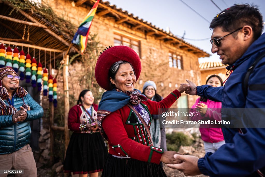 Portrait of a chinchero indigenous dancing with tourist, in Chinchero District, Peru