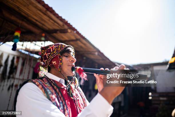 chinchero indigenous man playing flute on a market, in chinchero district, peru - flute musical instrument stock pictures, royalty-free photos & images