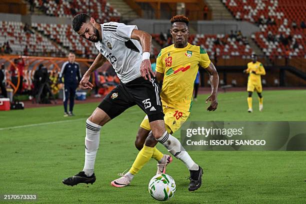 Benin's Francisco Dodo Dossou fights for the ball with Libya's Mustafa Majdi during the CAF Africa Cup of Nations group D qualification match between...