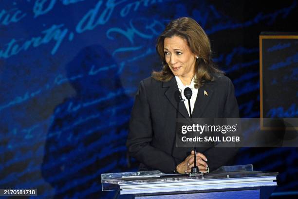 Vice President and Democratic presidential candidate Kamala Harris listens as former US President and Republican presidential candidate Donald Trump...