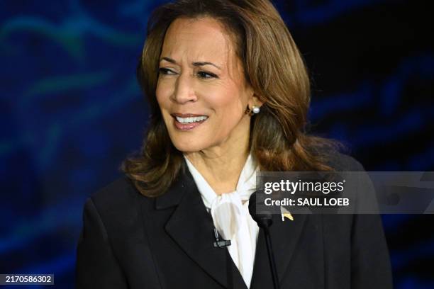 Vice President and Democratic presidential candidate Kamala Harris gestures as former US President and Republican presidential candidate Donald Trump...