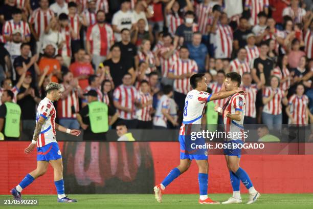 Paraguay's midfielder Diego Gomez celebrates with teammate midfielder Damian Bobadilla after scoring his team's first goal during the 2026 FIFA World...