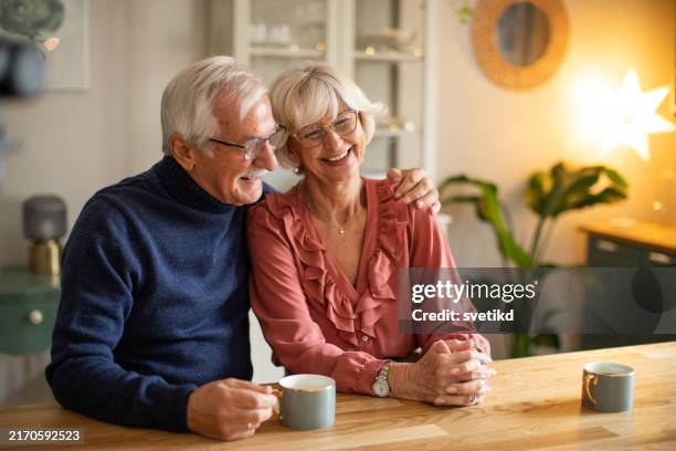 senior couple for christmas at home - older couple stock pictures, royalty-free photos & images