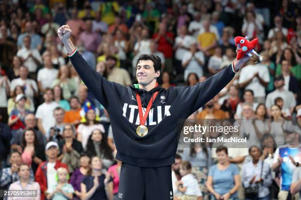Simone Barlaam of Team Italy celebrates on the podium after taking Gold in the Men's 100m Butterfly S9 final on day nine of the Paris 2024 Summer...