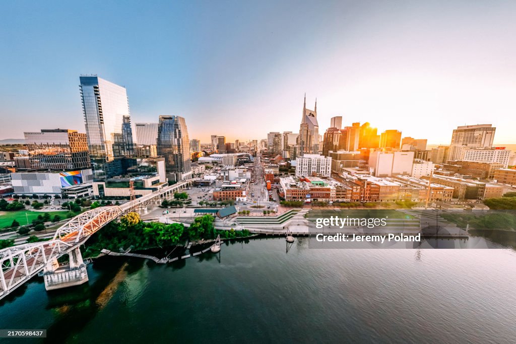 Wide Aerial View of Broadway, the Tourism Center of Downtown Nashville, Tennessee on a Sunny Summer Afternoon from the North Side of the Cumberland River near Nissan Stadium