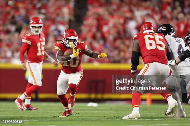 Running back Isiah Pacheco of the Kansas City Chiefs rushes the football against the Baltimore Ravens during the NFL game at GEHA Field at Arrowhead...