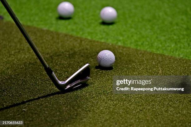 golfer plays golf indoors on golf simulator - simulatore foto e immagini stock