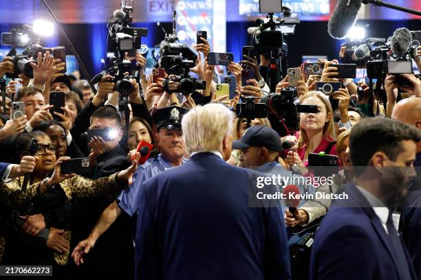 Republican presidential nominee, former U.S. President Donald Trump speaks to reporters in the spin room after debating Democratic presidential...