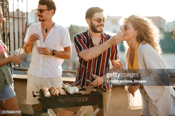 group of people at a rooftop party - utegrillat bildbanksfoton och bilder
