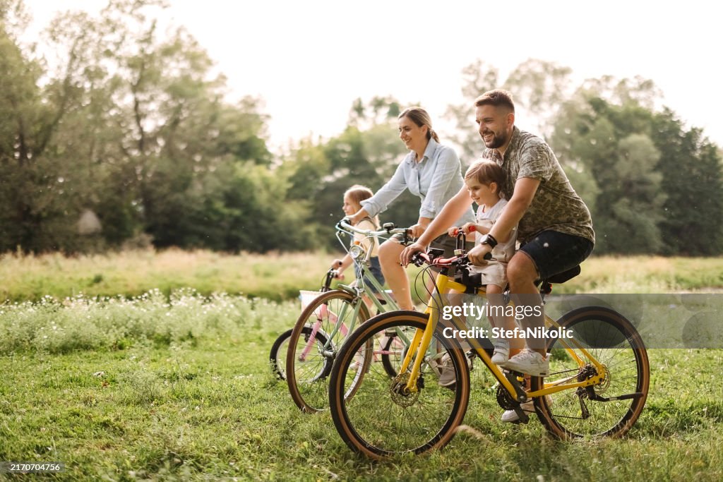 Family riding bicycles in the forest