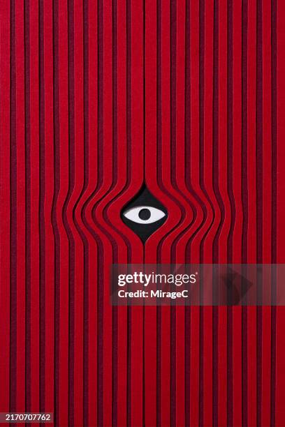 a spying eye peeking through the red curtain, paper craft - propagande photos et images de collection