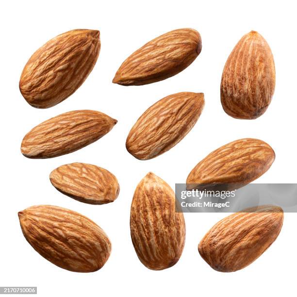 almonds isolated on white background - mandel stock-fotos und bilder