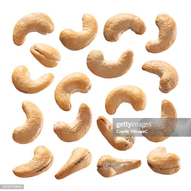 cashews isolated on white background - cashew stock pictures, royalty-free photos & images