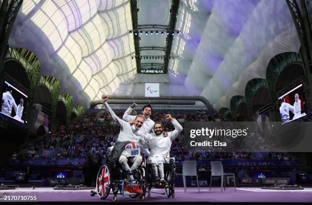 Piers Gilliver, Dimitri Coutya and Oliver Lam Watson of Team Great Britain celebrate winning bronze during the Wheelchair Fencing Men's Epee Team...