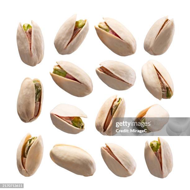 pistachios in shell isolated on white background - pistachio stock pictures, royalty-free photos & images