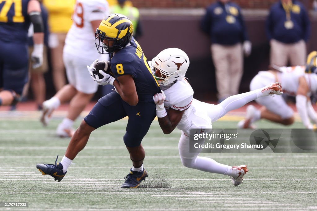 Tyler Rook Michigan Tyler Morris of the Michigan Wolverines is tackled by Gavin Holmes of ...
