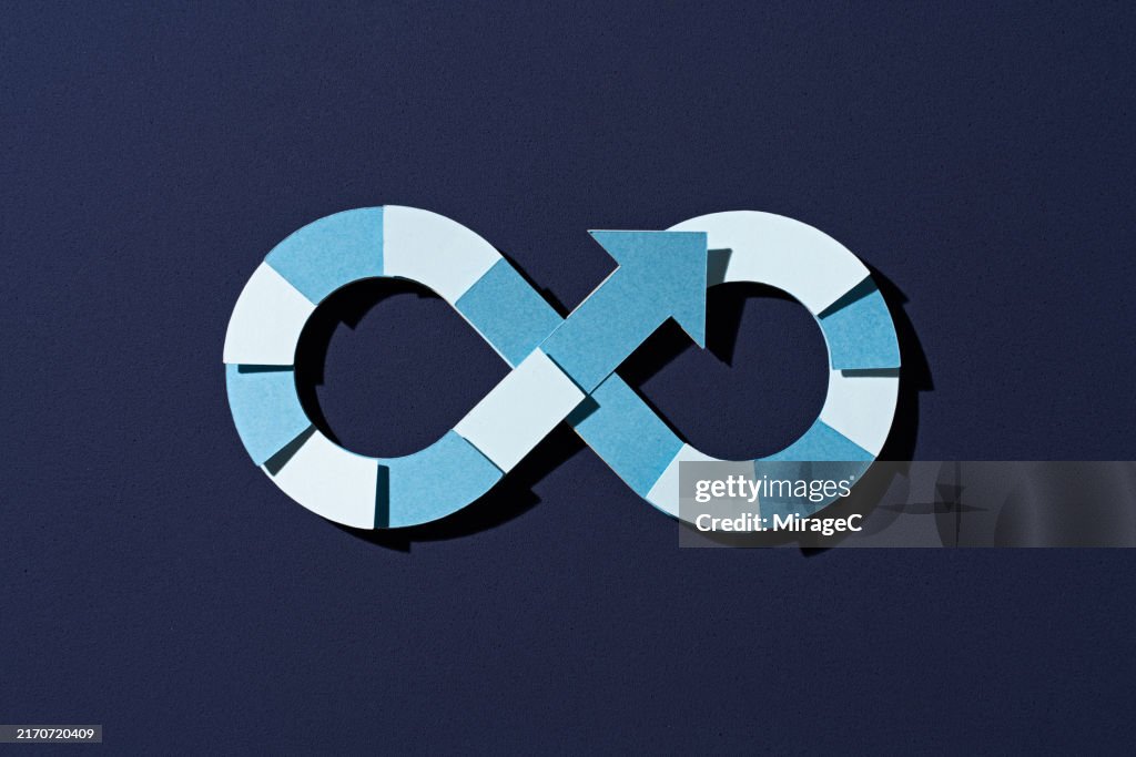 Paper Infinity Loop Blue Arrow Looping Within An Infinity Symbol Paper Craft High-Res Stock ...