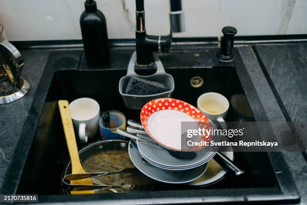 unwashed dishes in the kitchen sink - kitchen sink stock pictures, royalty-free photos & images