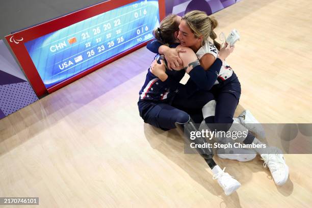 Bethany Paige Zummo and Kaleo Okalani Kanahele of Team United States celebrate winning gold during the Sitting Volleyball Women's Gold Medal match...