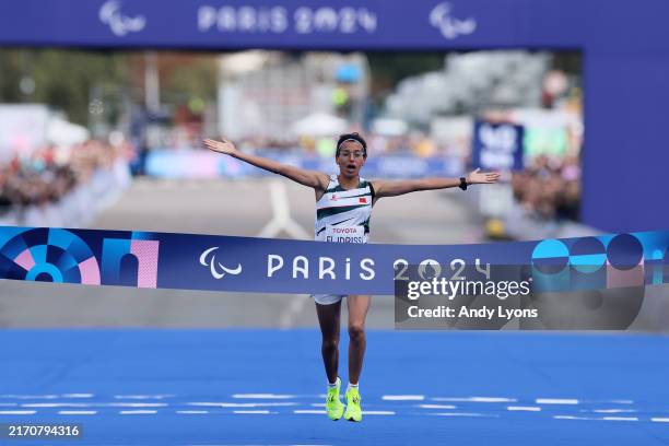 Fatima Ezzahra El Idrissi of Team Morocco celebrates crossing the finish line and taking the Gold Medal during the Women's T12 Marathon on day eleven...