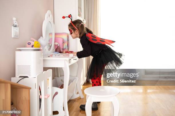 mirror magic: a girl’s halloween makeup comes to life - ladybug girl costume stock pictures, royalty-free photos & images